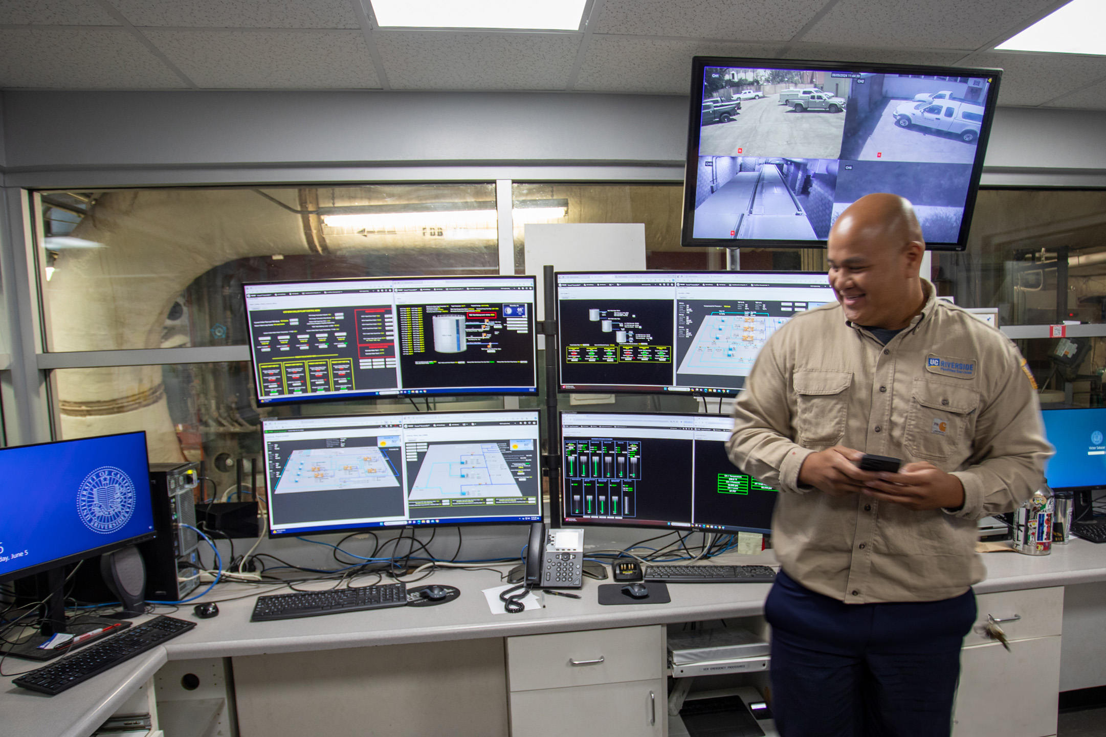 person monitoring screens in a control room