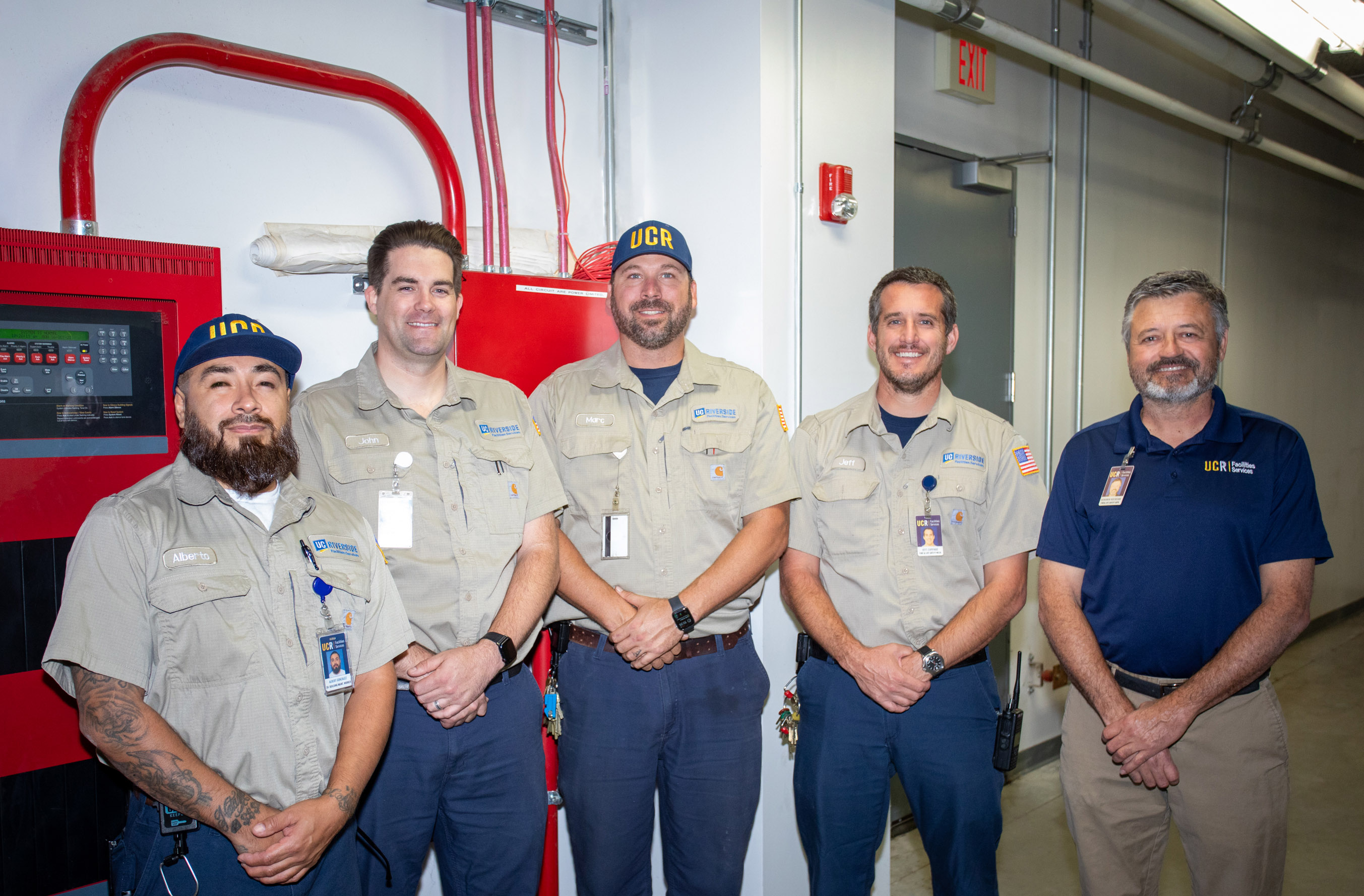 Technicians in front of fire and life safety equipment