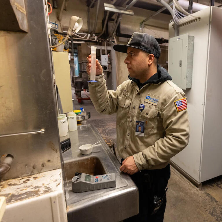 Plant operator reading a water test in a plant control room