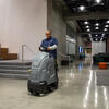 Custodial riding cleaning equipment in lobby