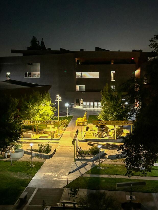 Exterior lighting of sidewalk looking down from the Arts Building